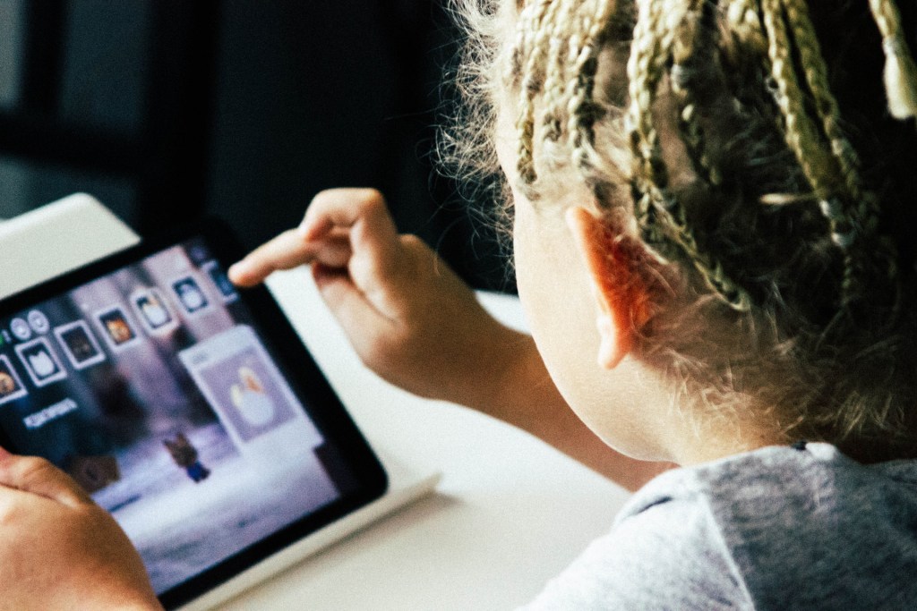 child playing with AAC devices